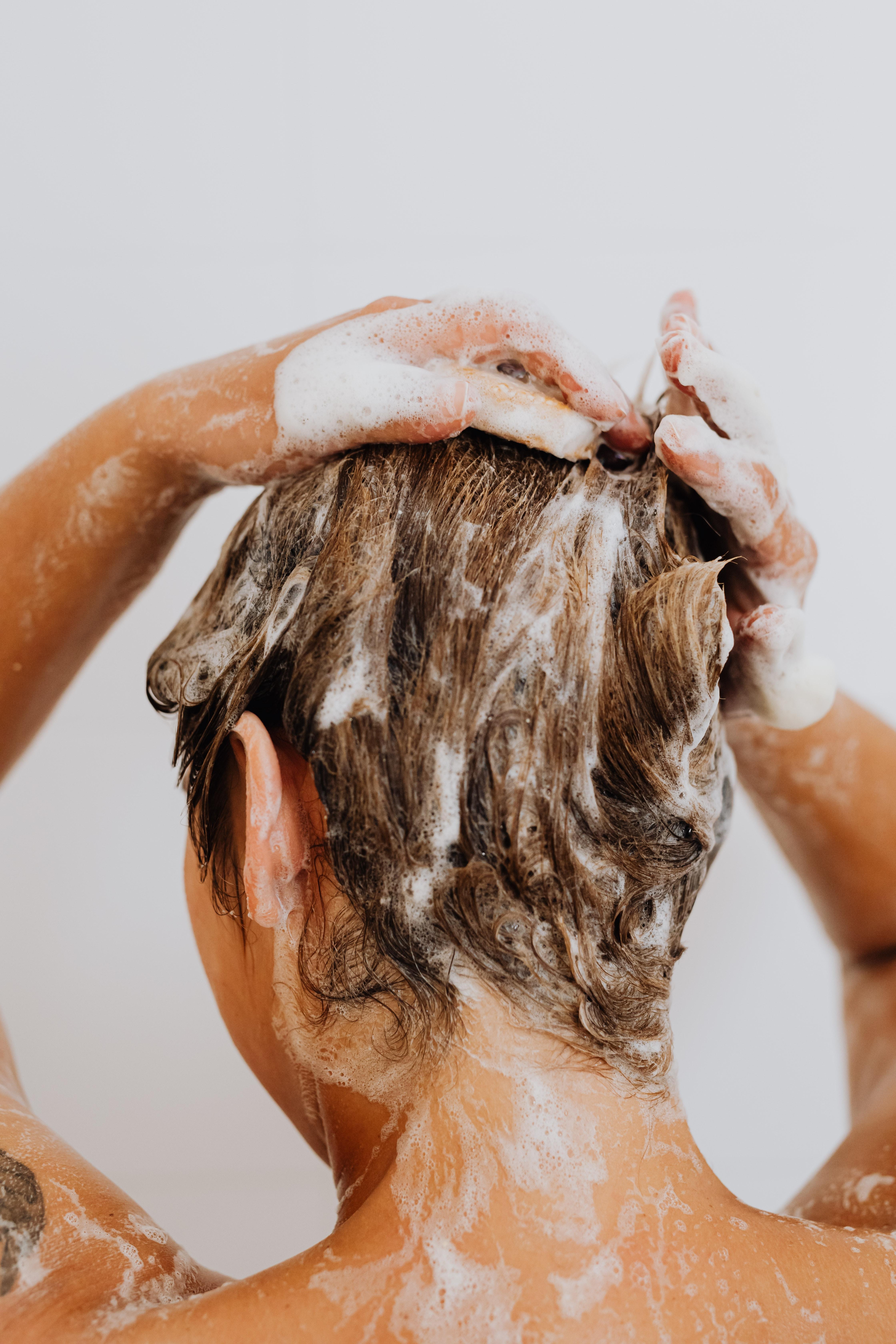 How can I wash my hair without getting my eyebrows wet? 