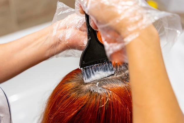 Should I wash my dyed hair with cold or hot water? 