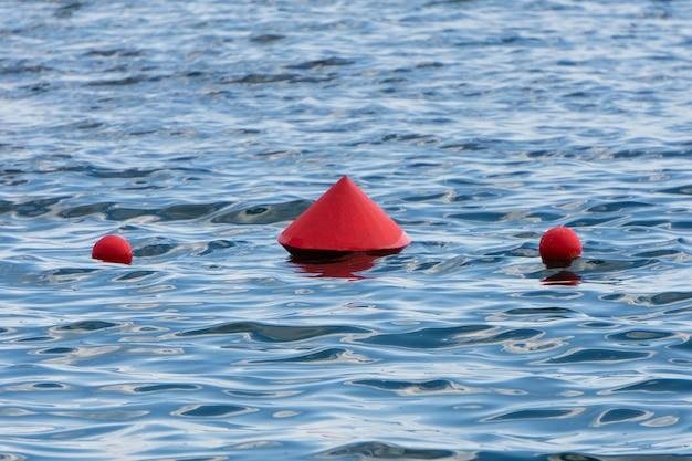 What does a red cone shaped buoy mark 